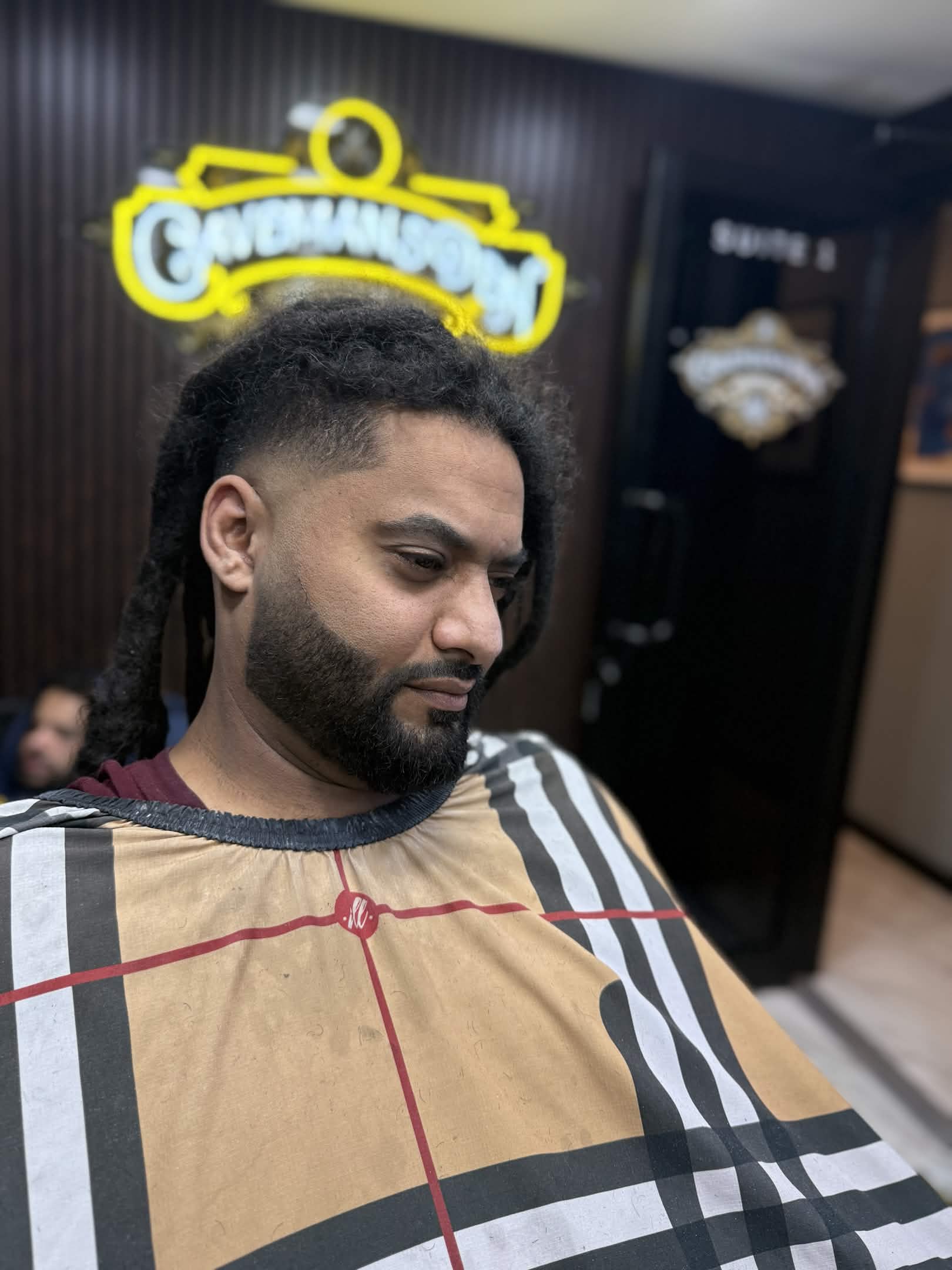 Dreads with taper fade sides and beard at Caveman's Den Astoria