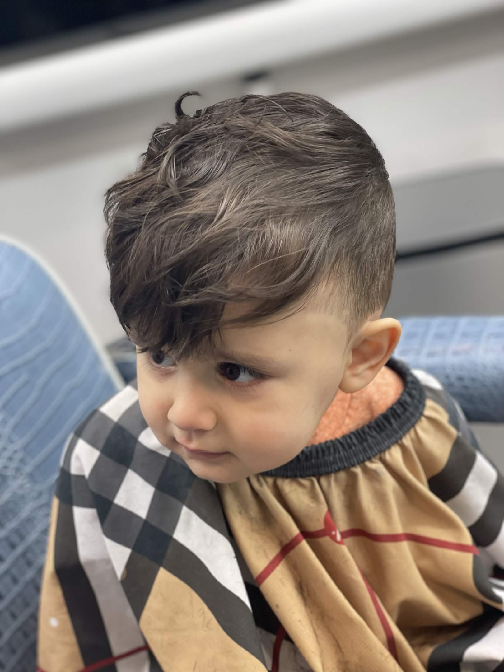Toddler first haircut — textured fringe with taper at Caveman's Den